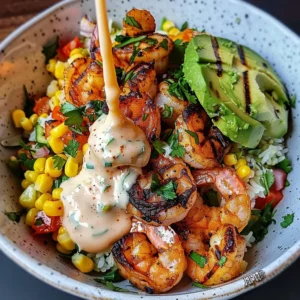 Grilled shrimp bowl with avocado, corn salsa, and creamy sauce.