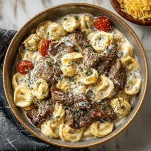 A delicious plate of Garlic Butter Steak with Cheesy Alfredo Tortellini