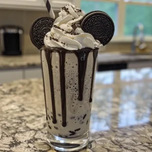 Close-up shot of an Oreo milkshake, showcasing its rich texture and toppings.
