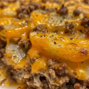 Juicy casserole filled with ground beef, thinly sliced potatoes, and melted cheddar cheese.