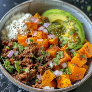 Side view of a savory bowl filled with ground beef, sweet potatoes, and cottage cheese.