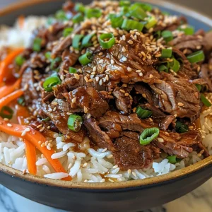 Juicy Korean BBQ Beef Bulgogi rice bowl captured with fresh ingredients and sesame seeds sprinkled on top.