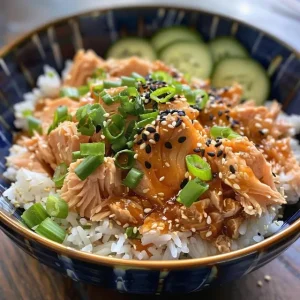 Appetizing spicy tuna rice bowl featuring colorful toppings and creamy sauce.