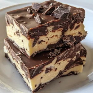 Textured piece of Cottage Cheese Fudge with visible chocolate chips and a shiny surface.