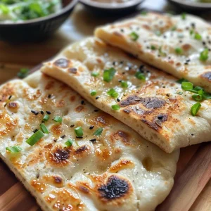 Juicy, fluffy flatbread on a wooden board, highlighting its inviting color and ingredients.