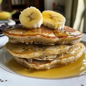 Delicious oat flour pancakes with a textured surface and syrup drizzle.