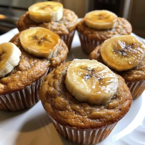 Delicious banana muffins arranged on a plate, showcasing their fluffy tops and warm color.