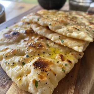 A detailed view of homemade flatbread, highlighting its soft interior and crisp exterior.