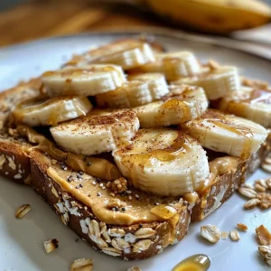 Whole grain bread spread with peanut butter, layered with banana slices, captured at an angle.