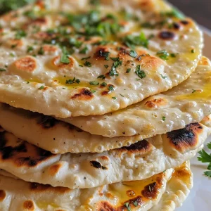 Juicy soft yogurt flatbread on a plate, garnished with sprinkled herbs and a drizzle of olive oil.