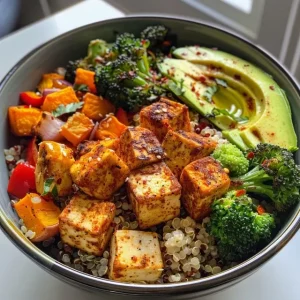 Close-up view of a Spiced Tofu and Roasted Veggie Quinoa Bowl with colorful vegetables.
