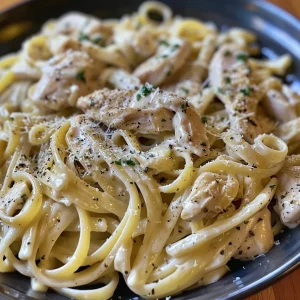 Close-up view of creamy Chicken Alfredo pasta topped with parsley.