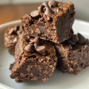 Delicious No-Bake Brownie Bites topped with shredded coconut and chopped nuts.