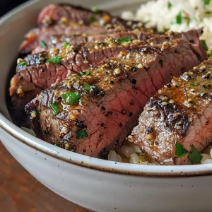 ['Close-up view of a Garlic Butter Steak & Rice Bowl with juicy steak slices and garnished rice.', 'Side view of a delicious Garlic Butter Steak & Rice Bowl featuring tender steak and aromatic herbs.', 'Juicy Garlic Butter Steak served over rice, showcasing vibrant garlic and parsley accents.', 'Detailed shot of a Garlic Butter Steak & Rice Bowl, highlighting the succulent steak and fluffy rice.']
