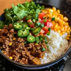 Close-up view of a Ground Beef Taco Bowl with colorful toppings.