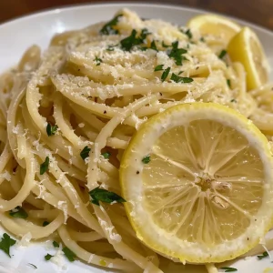Close-up of creamy Pasta al Limone with lemon zest and parsley.