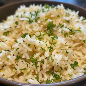 ['A close-up view of a vibrant Greek rice dish, featuring fluffy grains and herbs.', 'Juicy Greek rice with a side of fresh lemon and herbs, captured from a side angle.', 'A steaming portion of Greek rice garnished with parsley and dill, showcased from the side.', 'Detailed side view of Greek rice, highlighting the texture and colorful ingredients.']