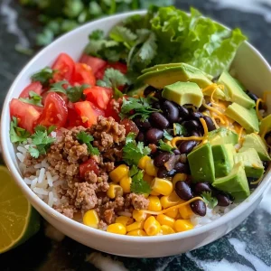 ['Close-up view of a Ground Beef Taco Rice Bowl with colorful toppings.', 'Juicy Ground Beef Taco Rice Bowl featuring rice, beef, and fresh veggies.', 'Side view of a filled taco rice bowl with ground beef and garnishes.', 'Appetizing Ground Beef Taco Rice Bowl showcasing layers of ingredients.']