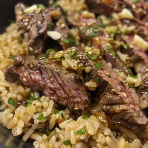 ['Close-up view of a honey garlic butter steak and rice skillet with juicy steak strips.', 'Side view of a delicious skillet featuring honey garlic butter steak and rice garnished with herbs.', 'Appetizing close-up shot of a hearty rice and steak dish glistening with honey garlic sauce.', 'Colorful presentation of honey garlic butter steak over rice in a skillet, showcasing tender meat.']