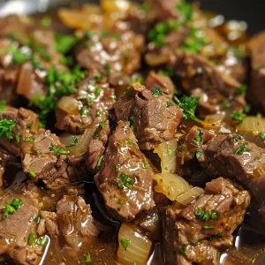['Juicy beef tips simmering in garlic butter sauce with visible garlic and herbs.', 'Close-up of tender beef tips in a rich, glossy garlic butter sauce.', 'Side view of Slow Cooker Garlic Butter Beef Tips garnished with fresh parsley.', 'Appetizing beef tips in a savory garlic butter sauce, ready to serve.']