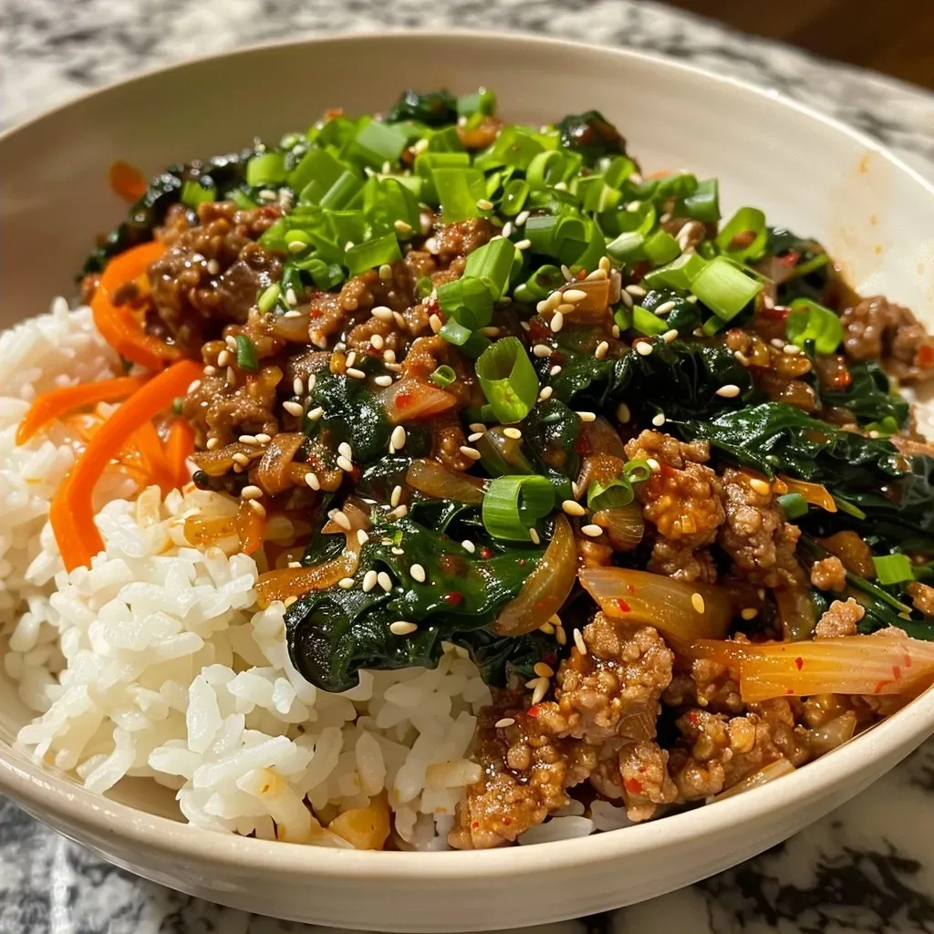 ['Close-up of Slow Cooker Korean Beef Spinach Rice served in a bowl with vibrant colors.', 'Side view of a delicious serving of Korean beef rice topped with spinach and vegetables.', 'Juicy Slow Cooker Korean Beef with spinach and rice, showcasing fresh ingredients in a bowl.', 'Tasty dish of Slow Cooker Korean Beef Spinach Rice, highlighting the beef and greens.']