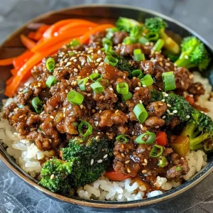 ['Juicy Teriyaki Ground Beef with colorful vegetables in a close-up view.', 'Glazed ground beef mixed with chopped bell peppers and broccoli, displayed attractively.', 'A side view of Teriyaki Ground Beef, garnished with sesame seeds and green onions.', 'Close-up image of savory Teriyaki Ground Beef with vibrant veggies.']