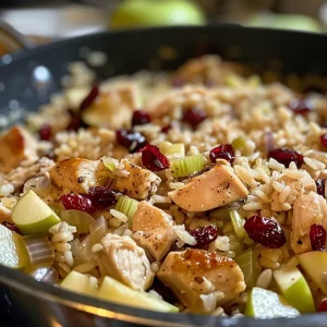 A close-up view of Apple Cranberry Chicken and Rice, showcasing colorful ingredients on a plate.