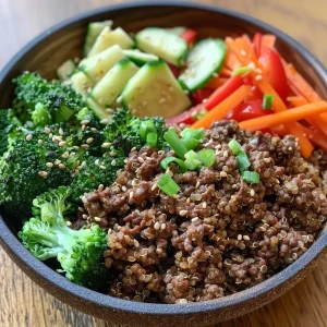 ['Close-up view of a meal prep bowl featuring high protein ground beef and quinoa, garnished with vegetables.', 'Side angle of a colorful meal prep bowl with quinoa, ground beef, and assorted vegetables like broccoli and bell pepper.', 'Juicy high protein ground beef and quinoa bowl with veggies, displayed in a meal prep container.', 'Detailed shot of ground beef and quinoa mix in a bowl, showcasing fresh ingredients and vibrant colors.']