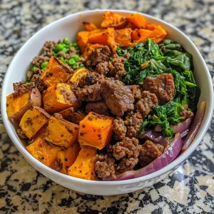 ['A close-up side view of a Sweet Potato Beef Bowl with vibrant ingredients.', 'Juicy Sweet Potato Beef Bowl filled with cubed sweet potatoes and ground beef.', 'An appetizing Sweet Potato Beef Bowl showing a mix of colorful vegetables and beef.', 'A delicious Sweet Potato Beef Bowl featuring seasoned beef and fresh greens.']