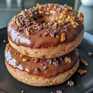 ['Close-up view of juicy Air Fryer Protein Donuts with a golden-brown exterior.', 'Side view of freshly baked protein donuts garnished with chopped nuts and chocolate chips.', 'Delicious Air Fryer Protein Donuts displayed on a plate, highlighting their soft texture.', 'Appetizing photo of protein donuts with a sprinkle of cinnamon and almond flour coating.']