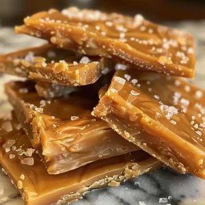 ['Close-up view of Arcor Milk Butter Toffee Candy with a shiny wrapper.', 'Side view of a single piece of Arcor Milk Butter Toffee Candy, showcasing its texture.', 'Detailed shot of Arcor Milk Butter Toffee Candy on a textured surface.', 'Focused image of Arcor Milk Butter Toffee Candy highlighting its golden color.']