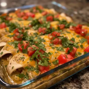 ['Close-up view of juicy chicken enchiladas topped with melted cheese and garnished with cilantro.', 'Side perspective of chicken enchiladas with vibrant red sauce, cheese, and diced tomatoes on a plate.', 'Juicy chicken enchiladas served on a white plate, with a rich layer of cheddar and Monterey Jack cheese.', 'Appetizing close-up of chicken enchiladas, showcasing their filling and colorful toppings.']