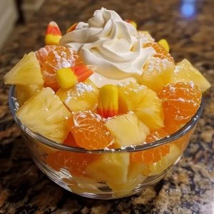 ['Close-up view of a vibrant healthy candy corn snack featuring pineapple and mandarin oranges.', 'Side angle of a colorful bowl filled with pineapple, mandarin oranges, and candy corn.', 'Juicy fruit salad made with pineapple and mandarin oranges, topped with candy corn.', 'Healthy candy corn snack arranged with chunks of pineapple and mandarin oranges, garnished with candy corn.']