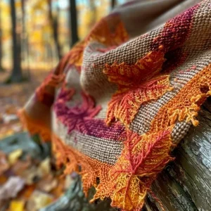 ['Close-up view of a Maple Leaf Shawl showcasing intricate knitting patterns.', 'Detailed side view of a knitted Maple Leaf Shawl, showing texture and color.', 'Close-up image of a Maple Leaf Shawl with vibrant yarn colors and patterns.', 'Side profile of a beautifully knitted shawl featuring a maple leaf design.']
